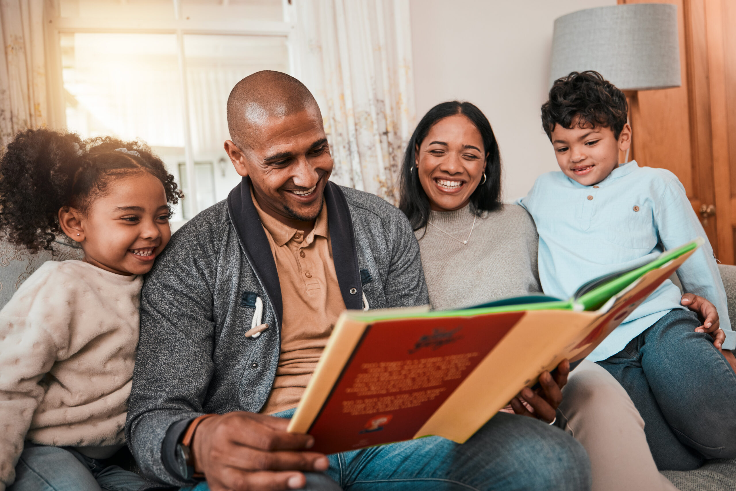 Family reading a storybook together at home
