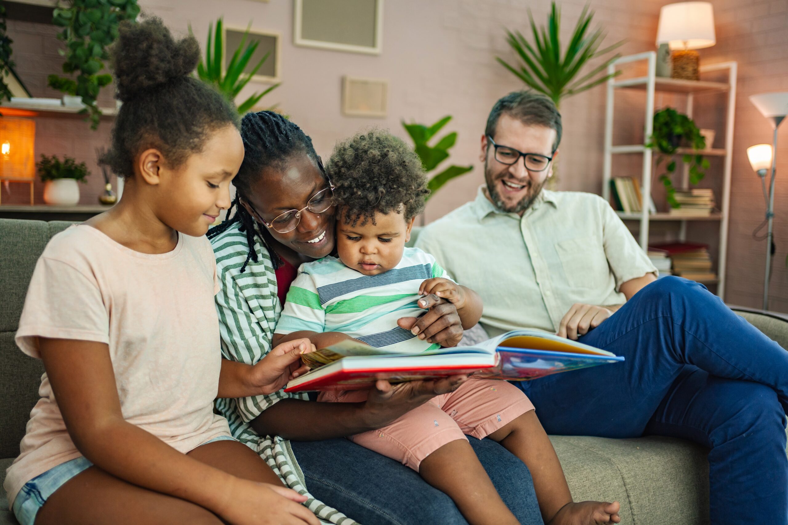 Family sharing story time together in a living room