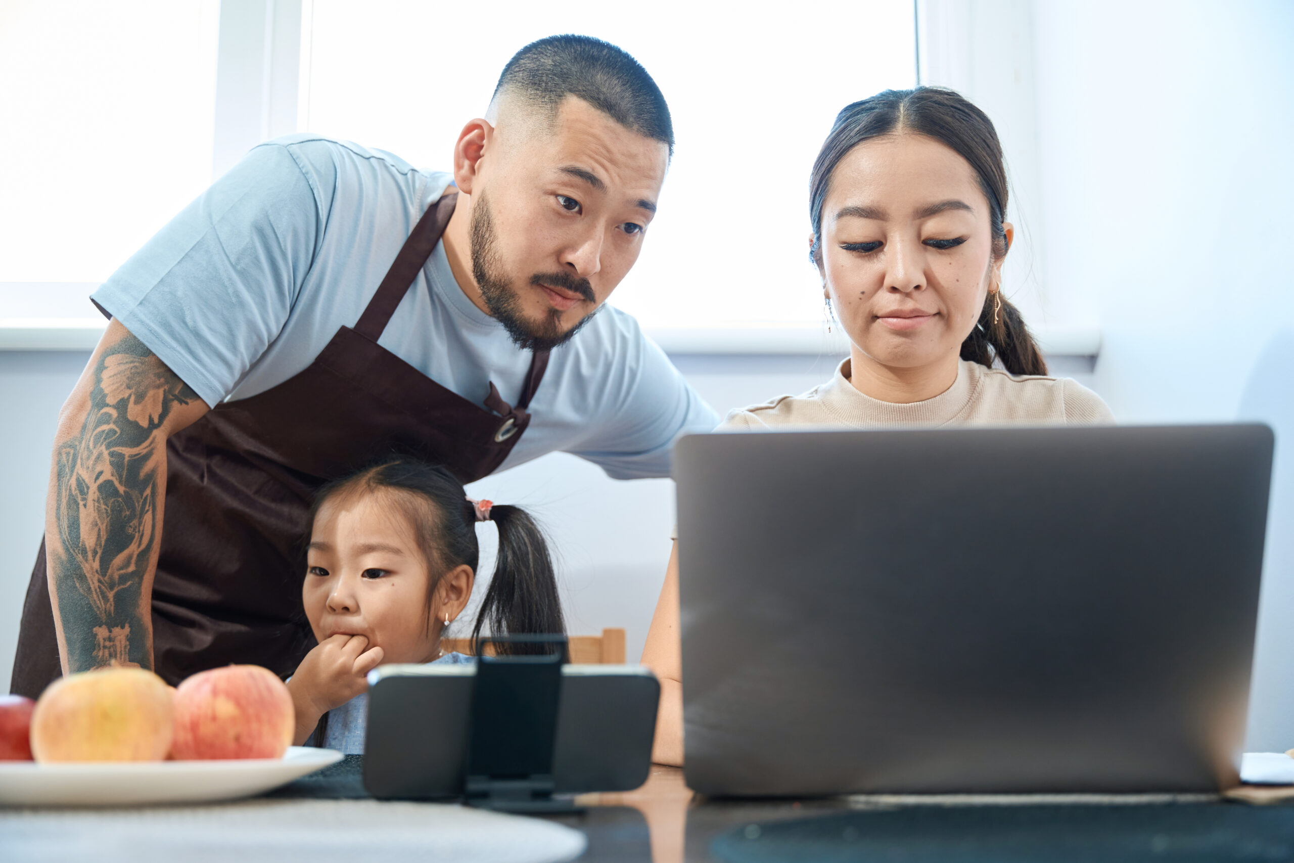 Family using a laptop together at a table